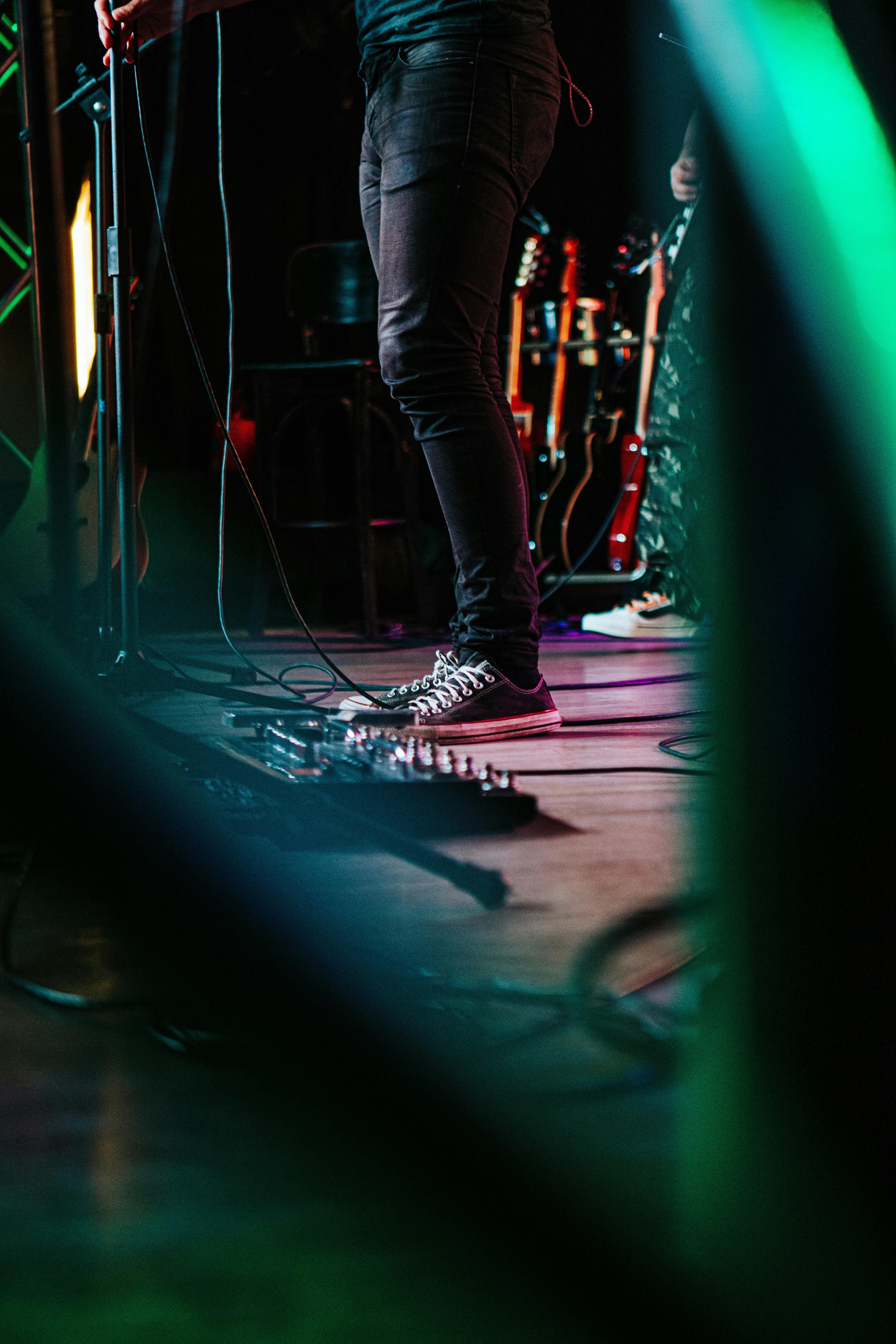 Musician recording and mixing audio, representing the Band OS audio library and stem mixer